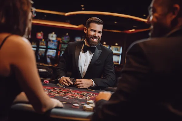 A young woman relaxing with her phone while dynamic casino elements float around her, illustrating the smooth mobile experience offered by the KKBDD app.