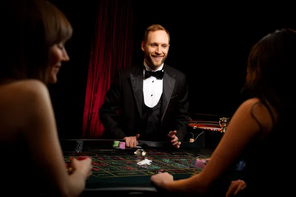 A player using their smartphone during a festive local event, representing KKBDD’s fully mobile-friendly casino.